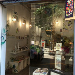 Shop with colorful paintings and plants